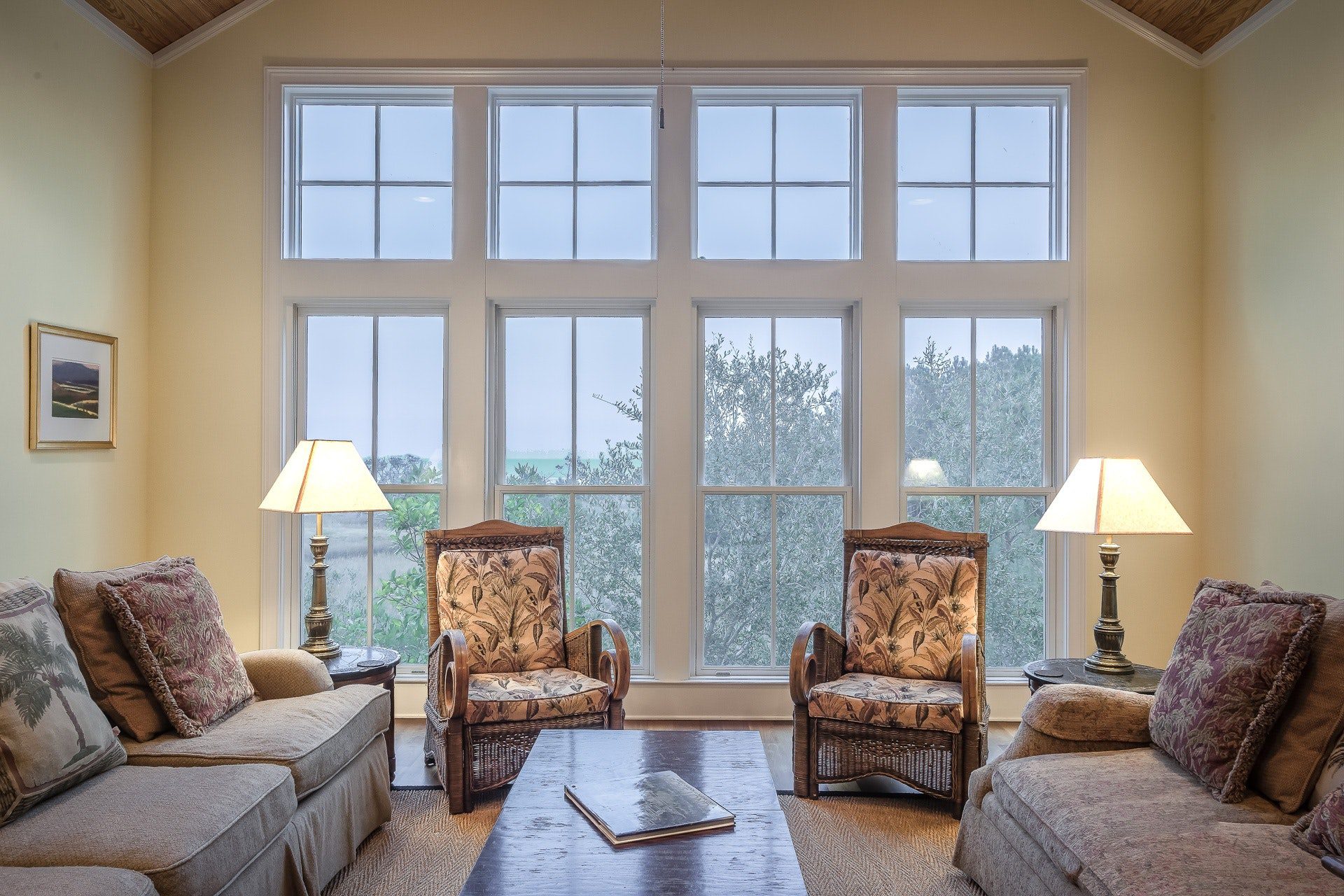 f2ac82d7-4765-4c6f-8c3e-b261b271a4ea (1) Cozy living room with floral armchairs and large window.